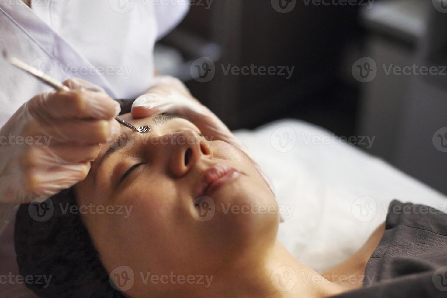 Professional cleansing of acne in a beauty salon photo