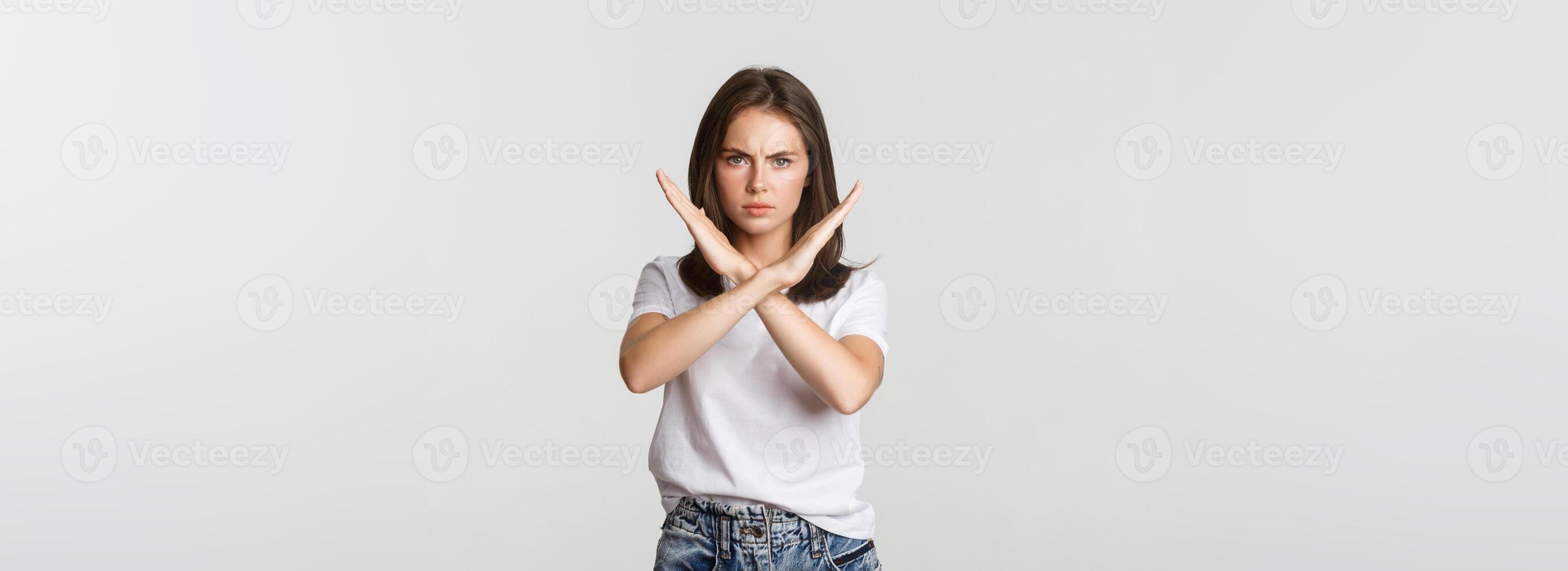 Serious angry woman showing cross, stop something bad, express disapproval or dislike photo
