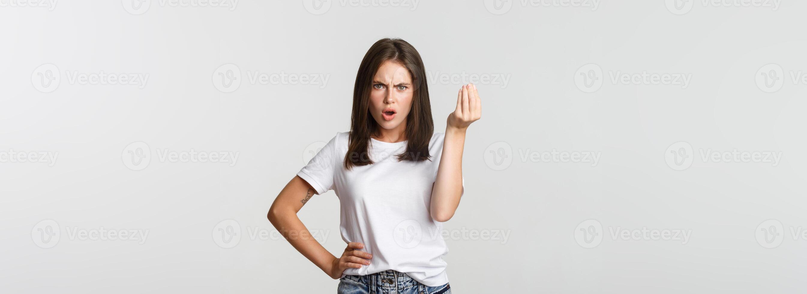 Confused and angry brunette girl arguing about money photo