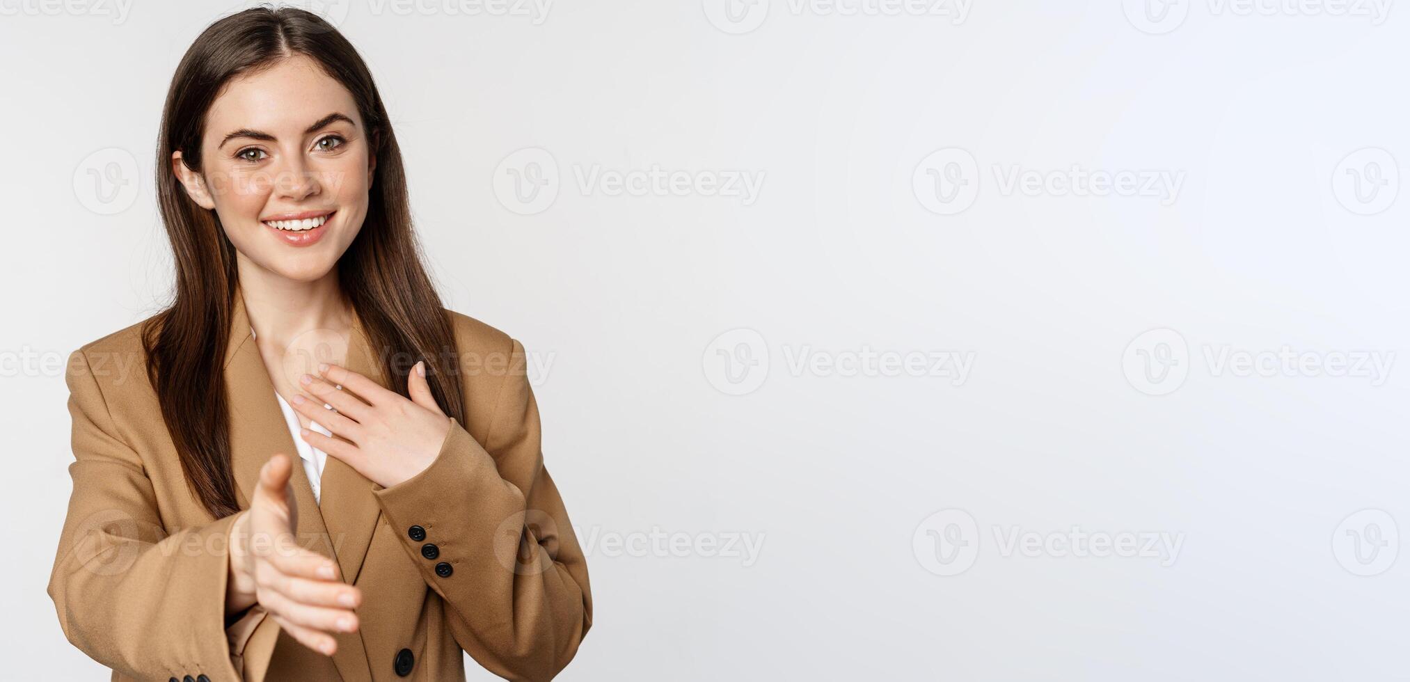 Portrait of smiling businesswoman extend hand for handshake, greeting business partner, saleswoman welcome client, white background photo