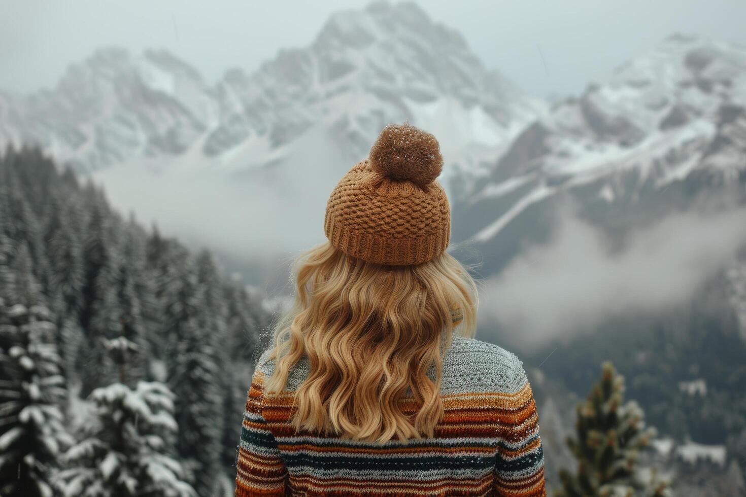 Woman Admires Snowy Mountain Range in Winter photo