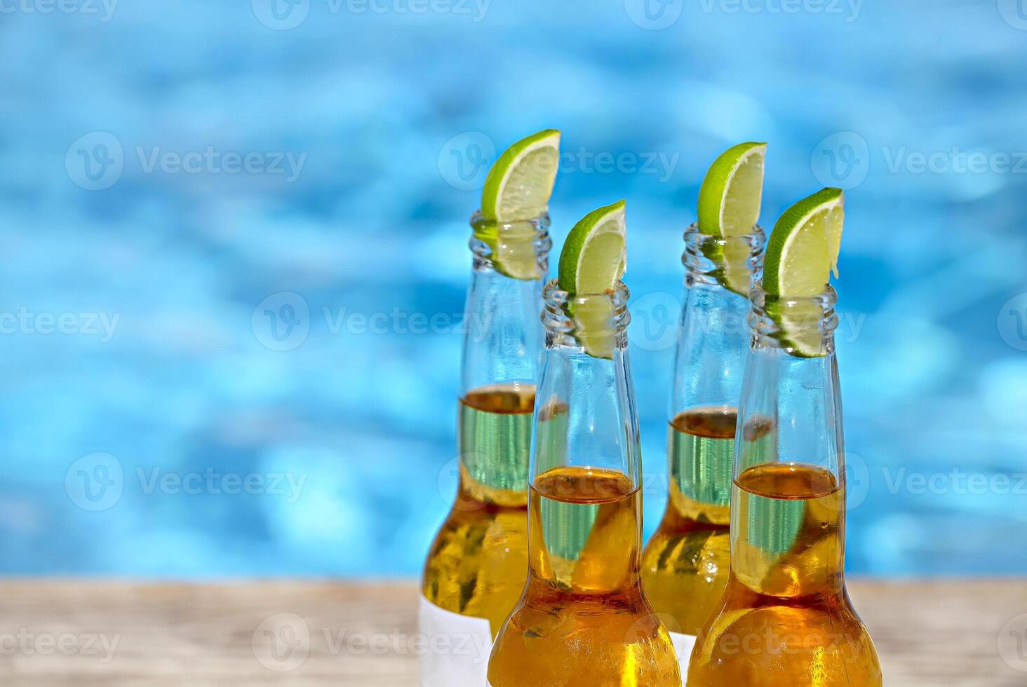 Closeup view of beer bottles and lime slices photo
