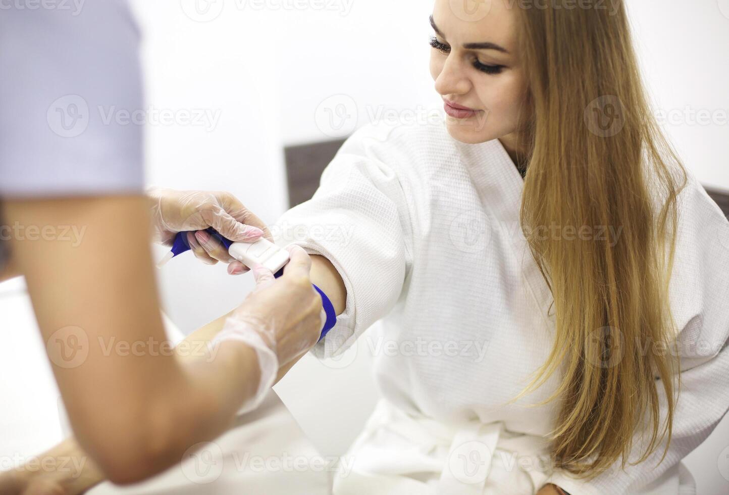 Young patient during blood test sampling procedure photo