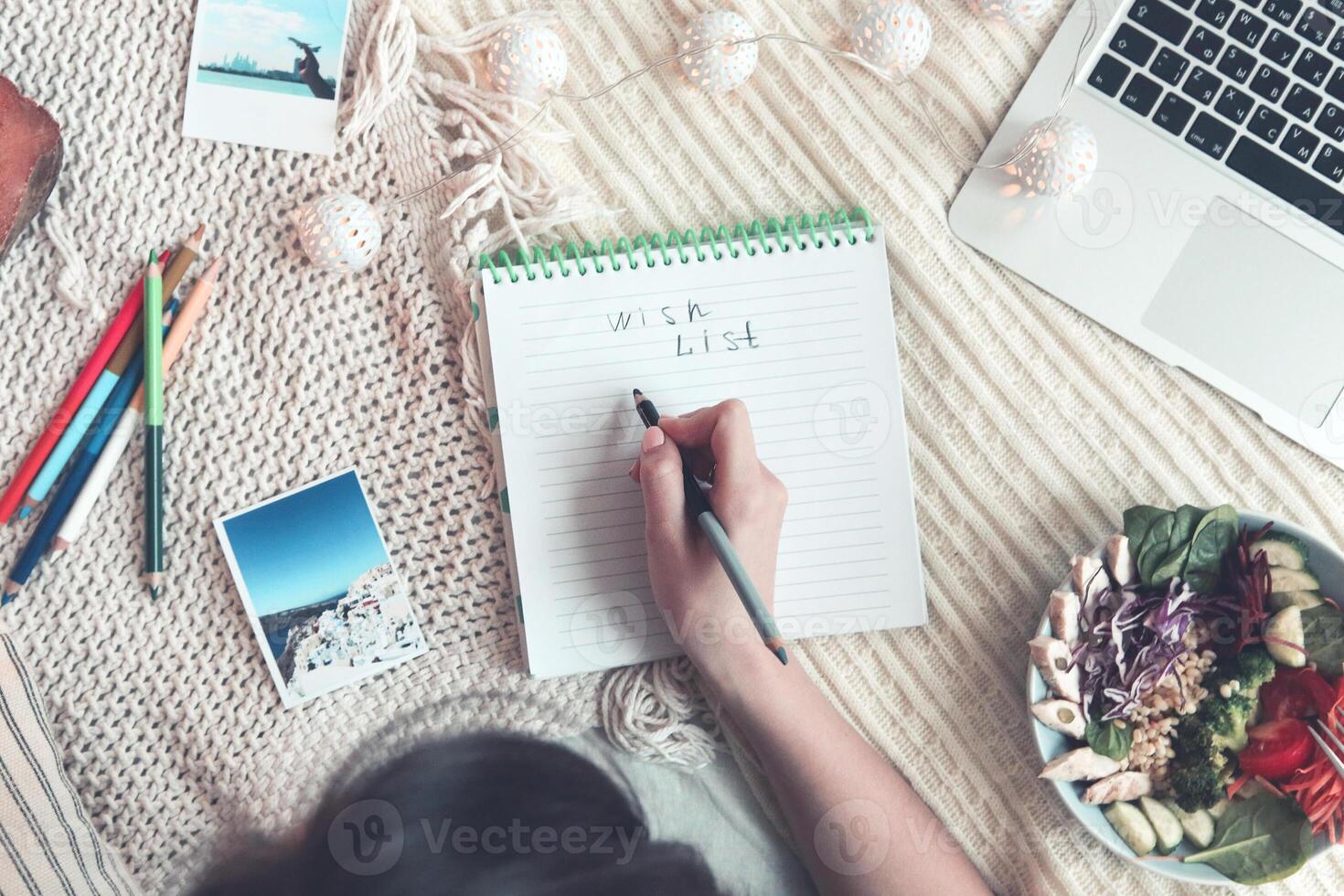 Crop woman creating wish list photo