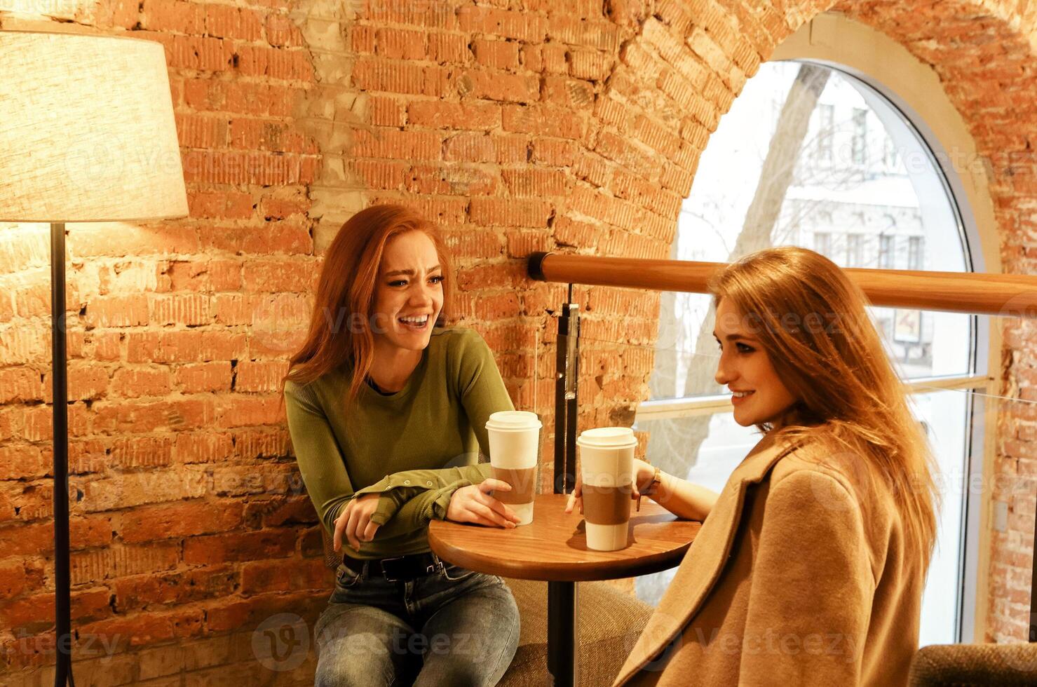 Cheerful multiethnic women enjoying lunch in cafe photo