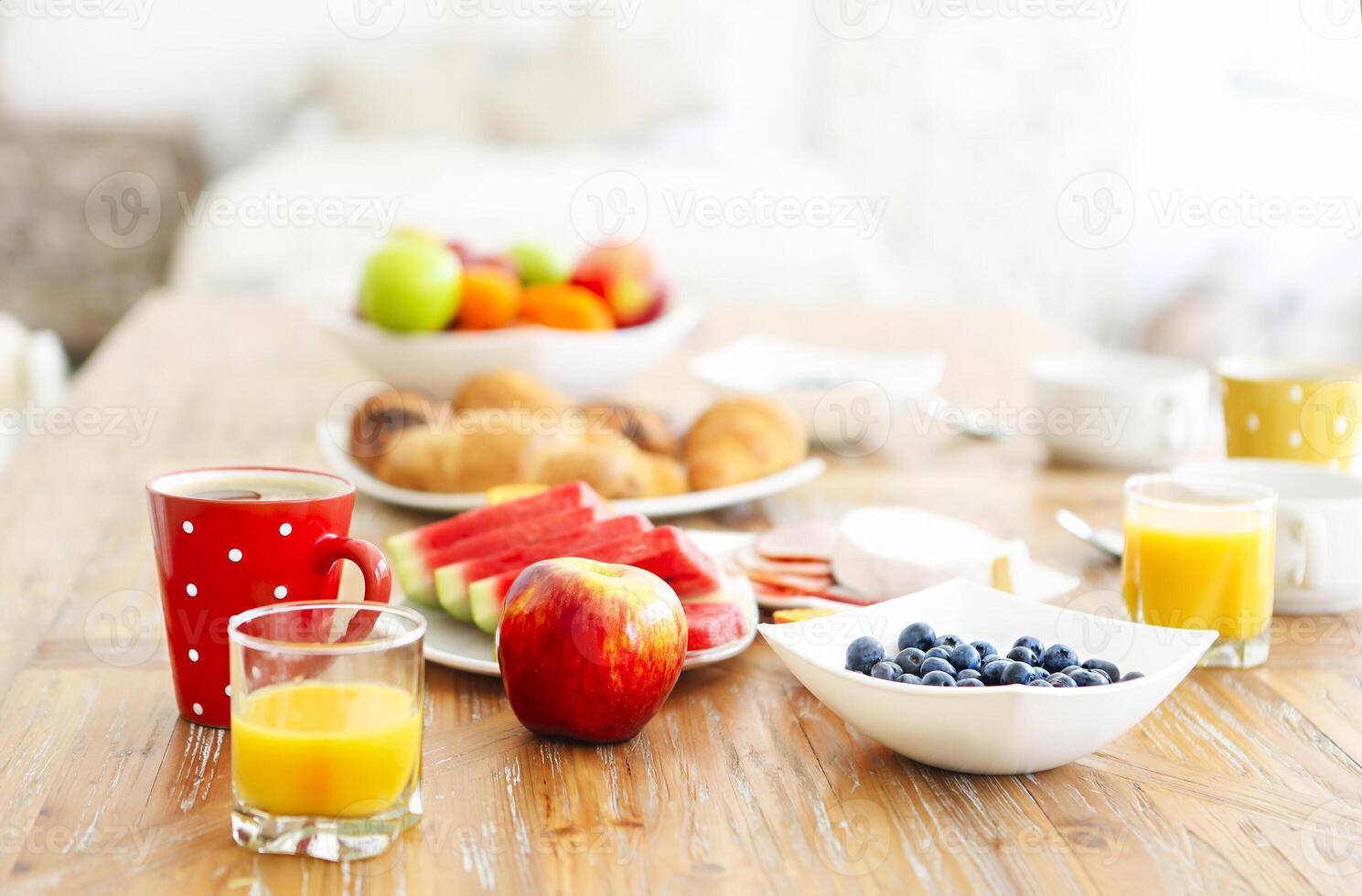 Coffee with fruit, cereal and croissant on wooden table background photo