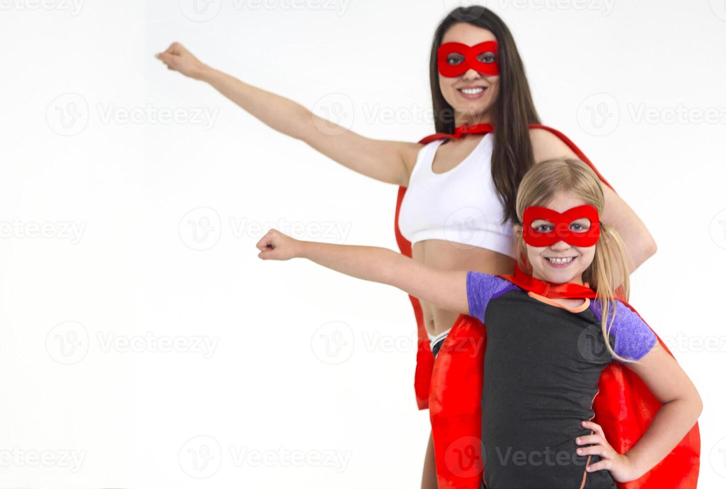Young superwoman and supergirl wearing sport clothes and looking fun photo