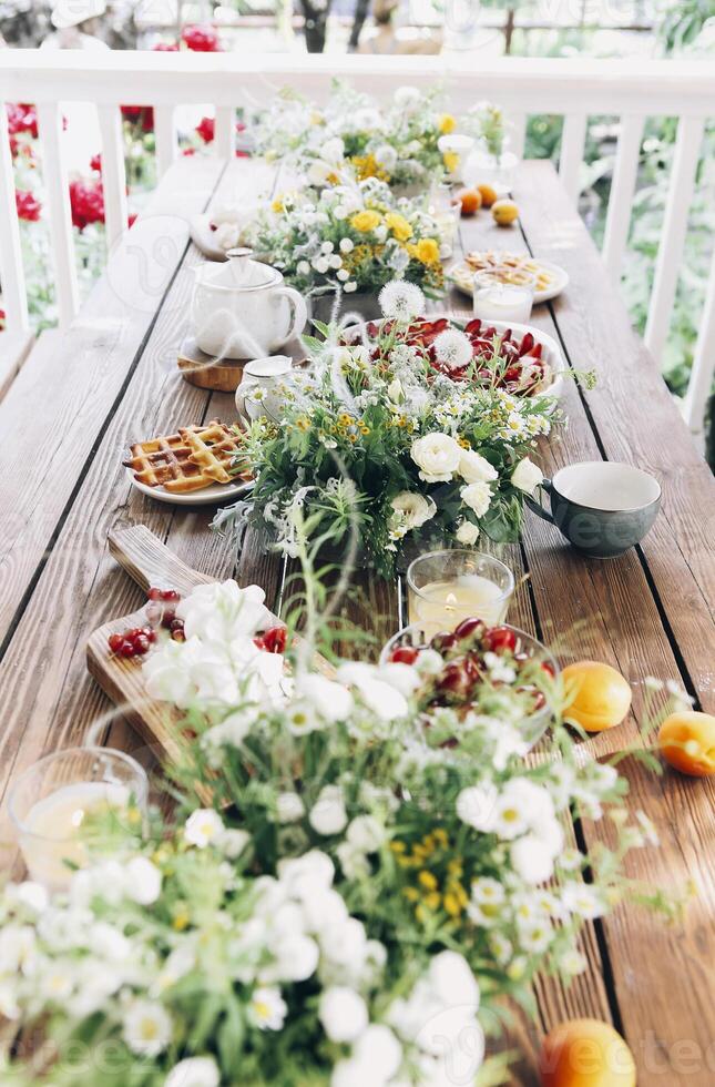 Appetizing breakfast on table on terrace photo