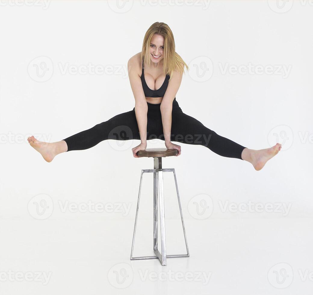 Fit young woman training. Beautiful female athlete working out for wellbeing in domestic gym, training legs muscles photo