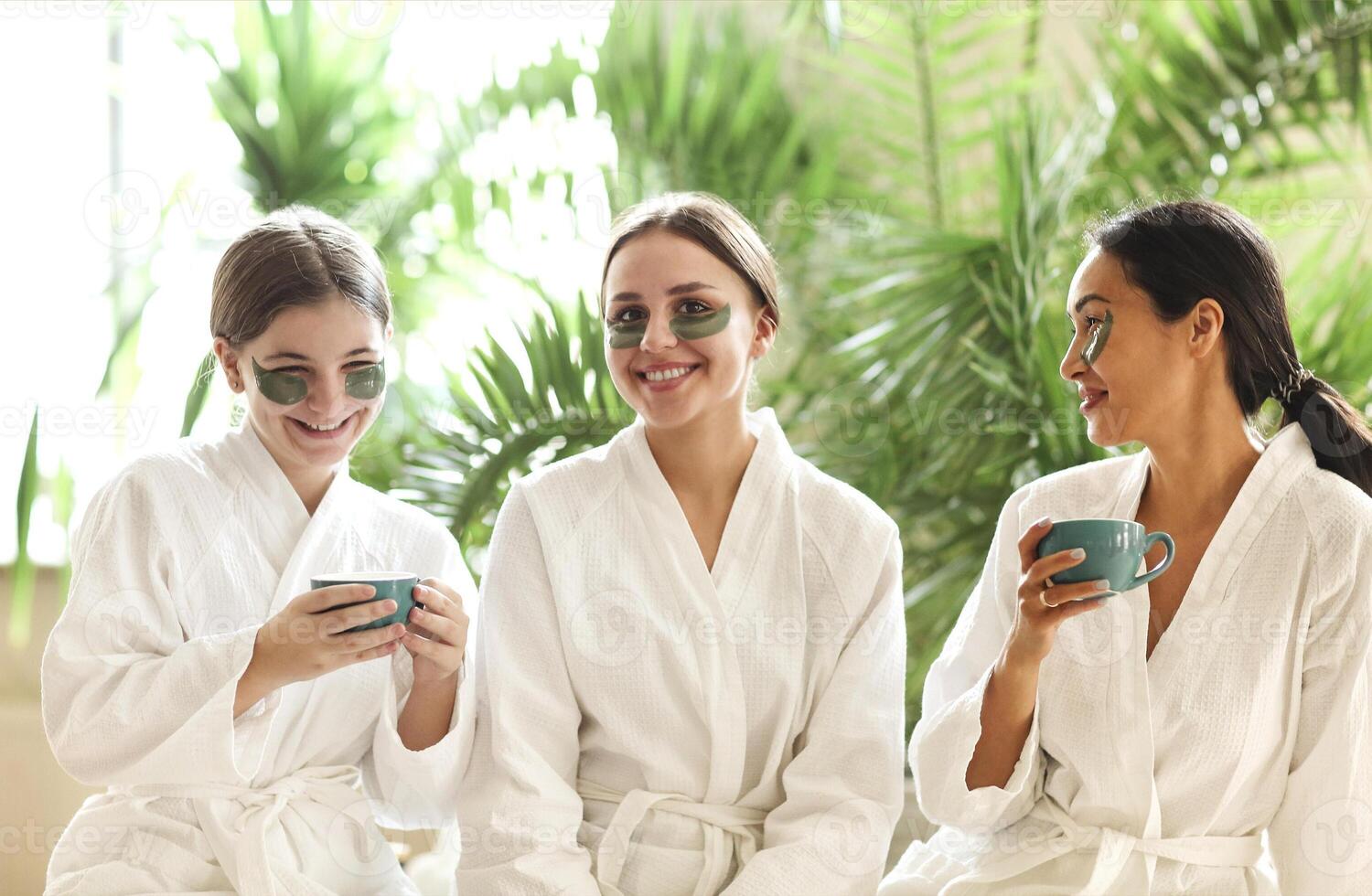 Company of girls in bathrobes and eye patches photo