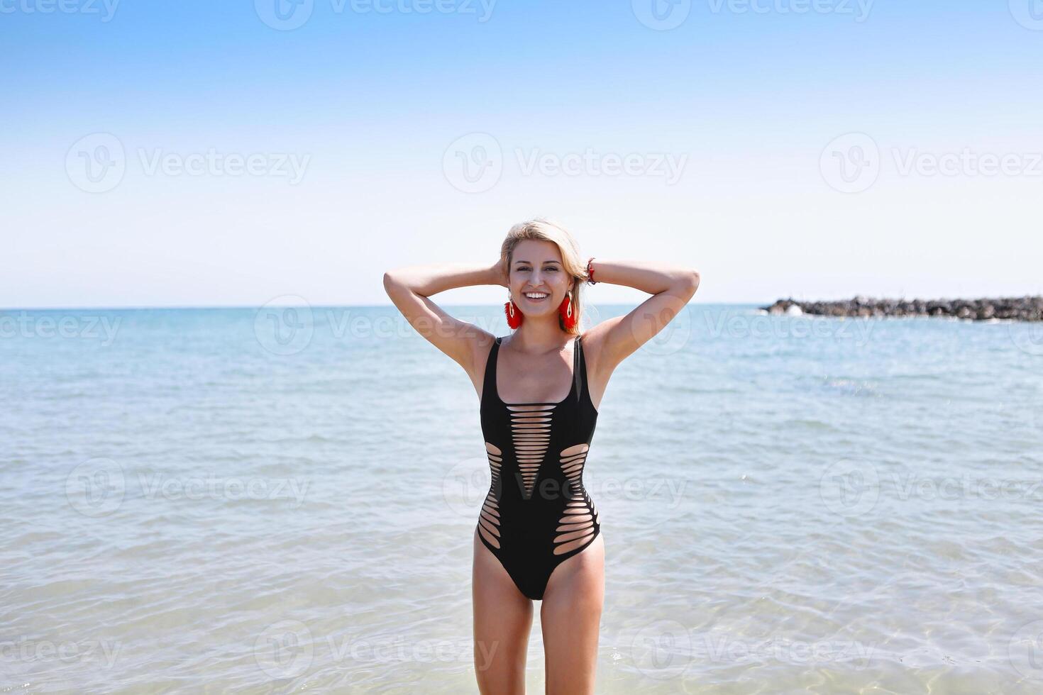 Woman in black swimwear on the beach photo