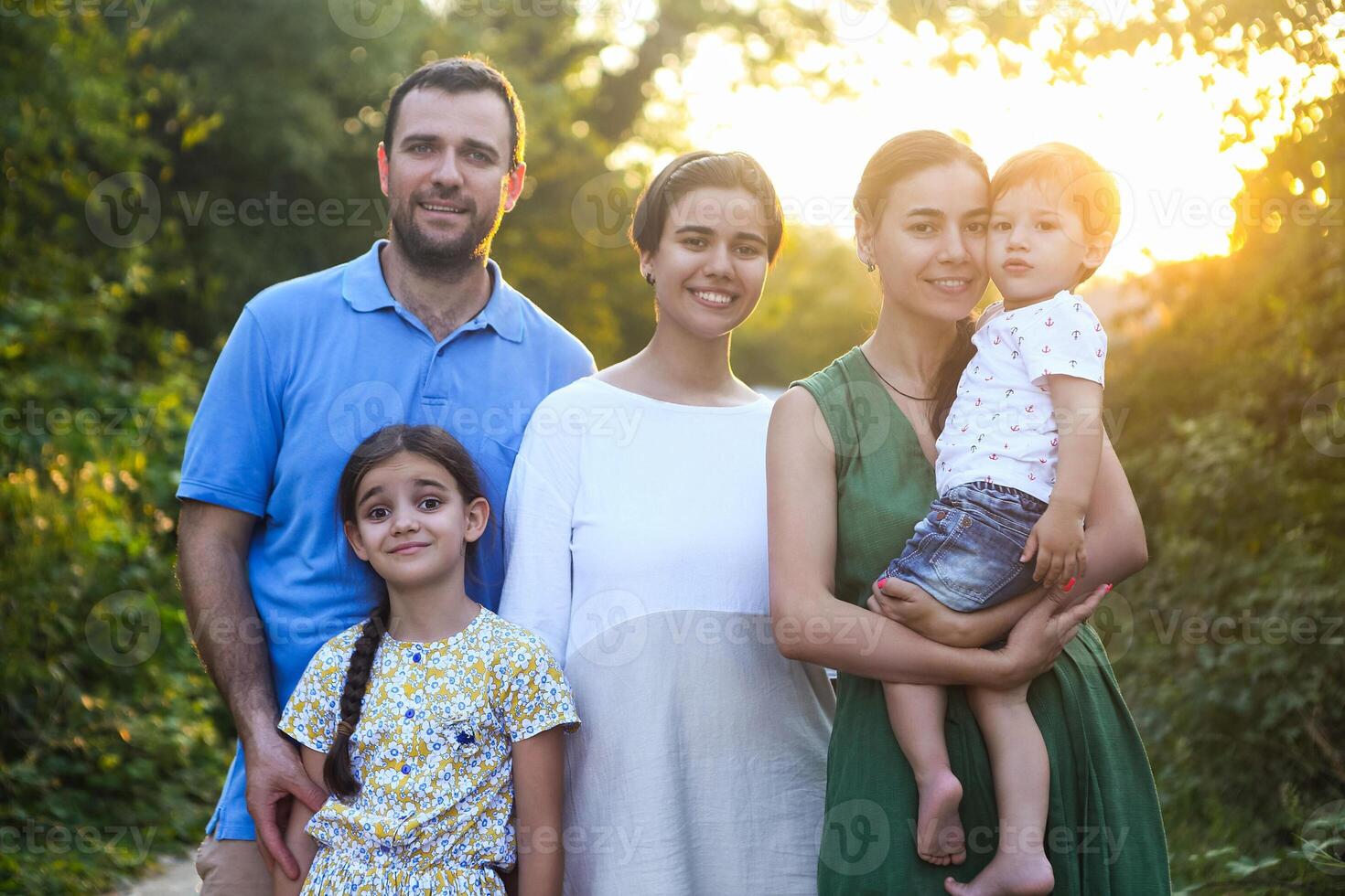 Portrait of the big happy family. Parents with children in countryside photo