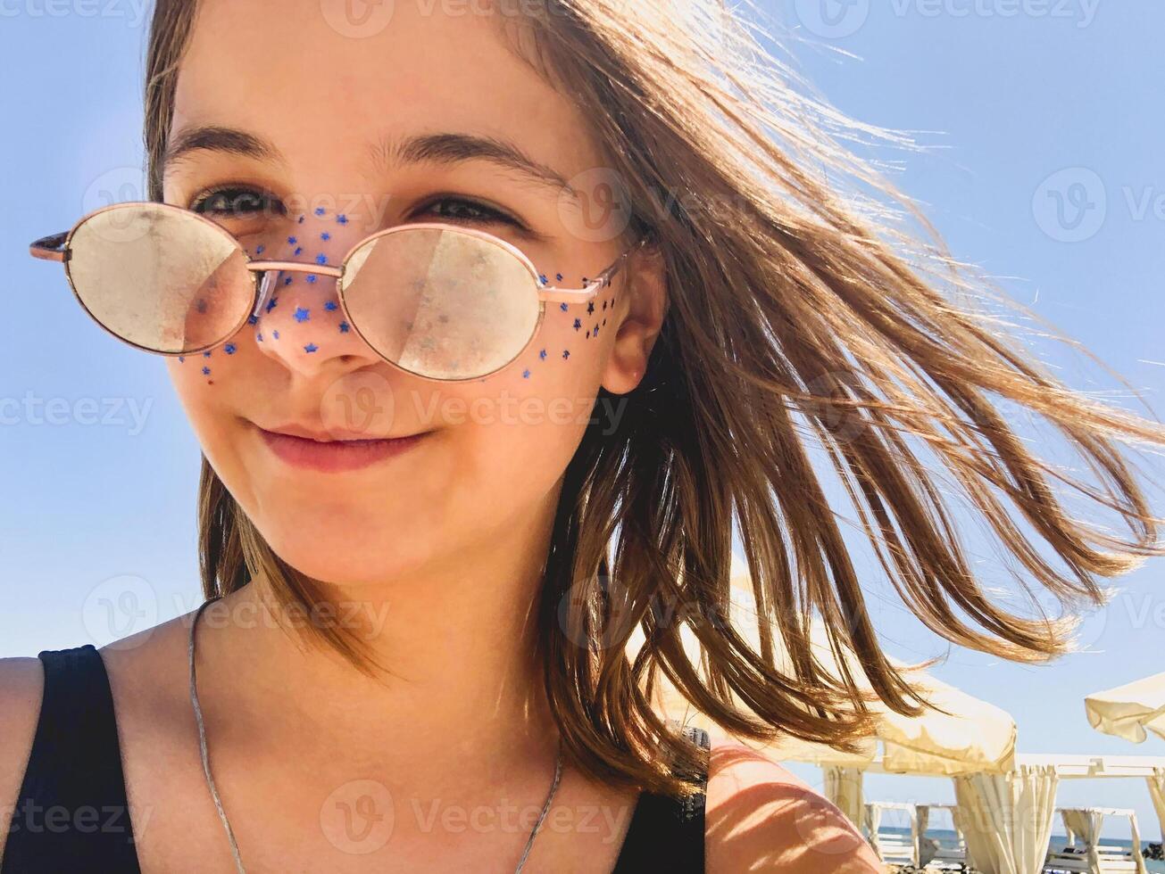 Smiling teenager on beach in summer photo
