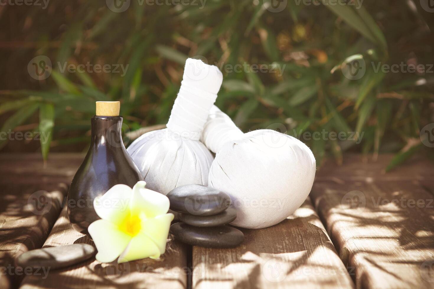 Spa supplies on wooden floor in garden photo