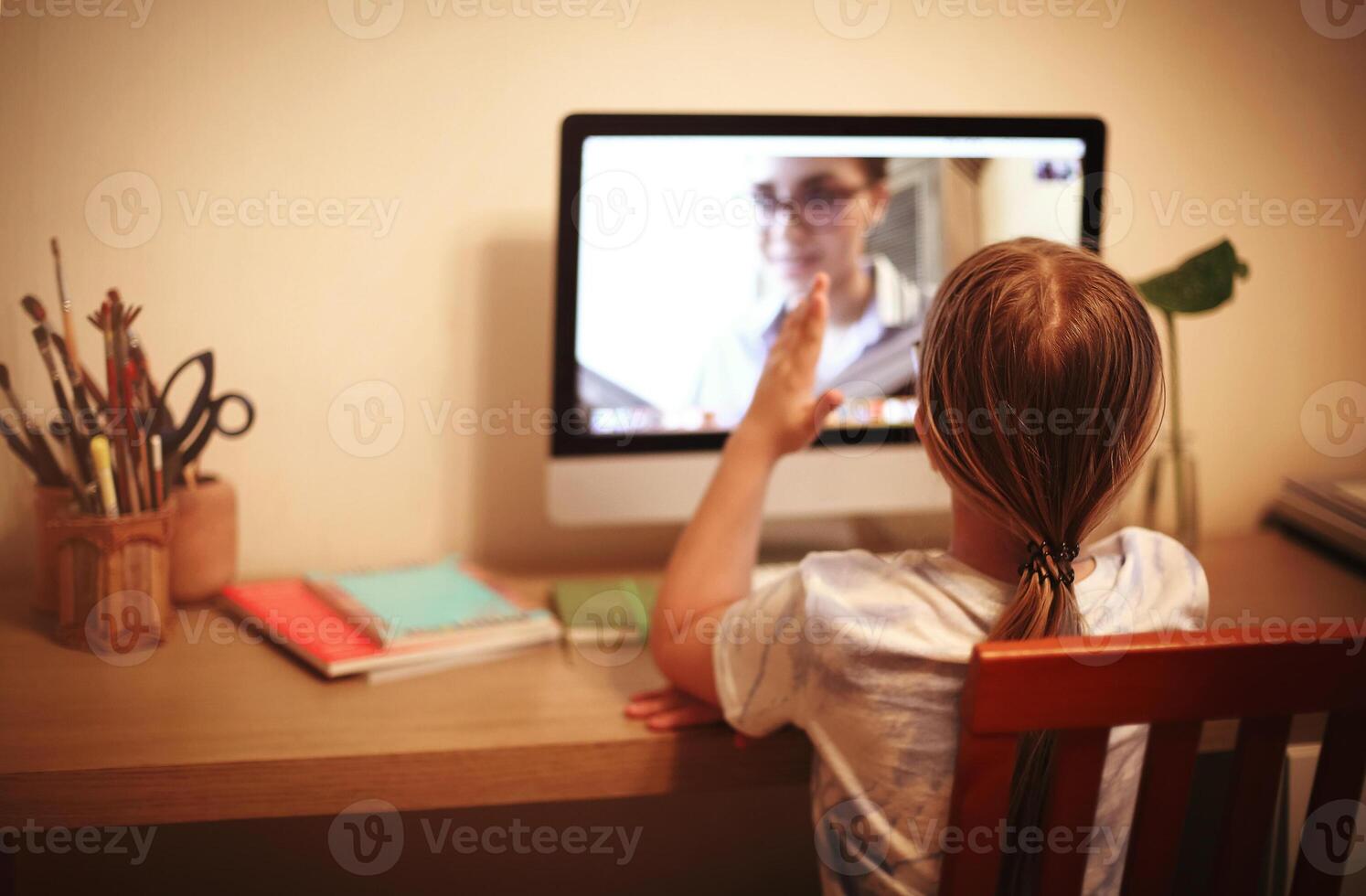 Unrecognizable girl ready to answer to online teacher photo