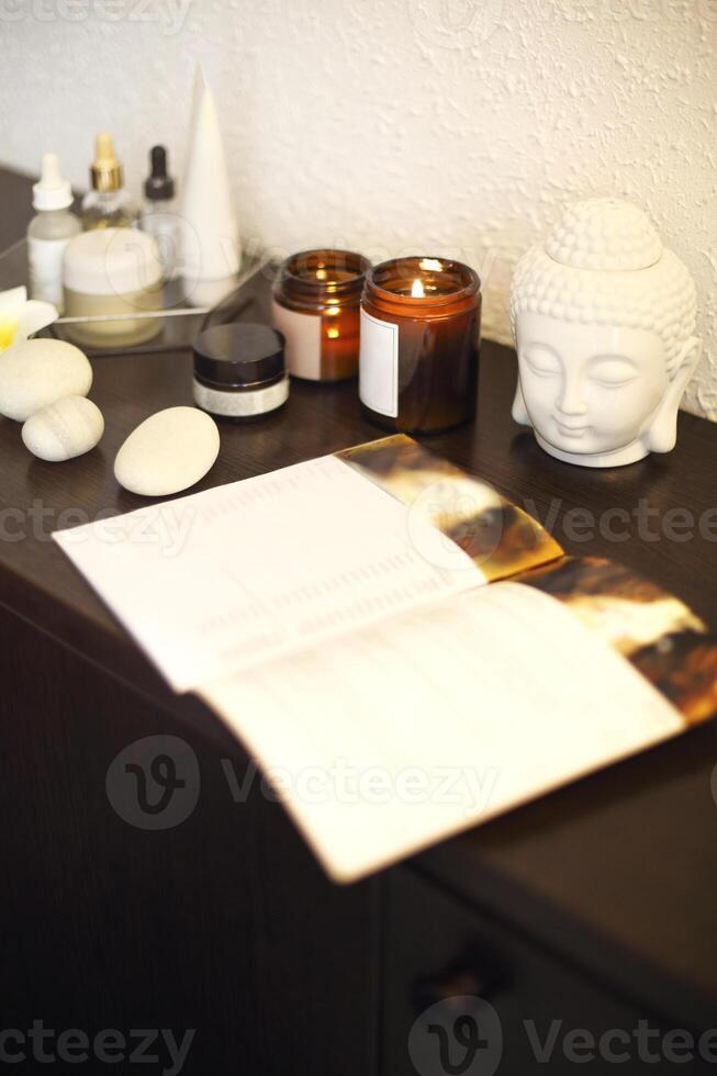 Candles and skincare products on table photo
