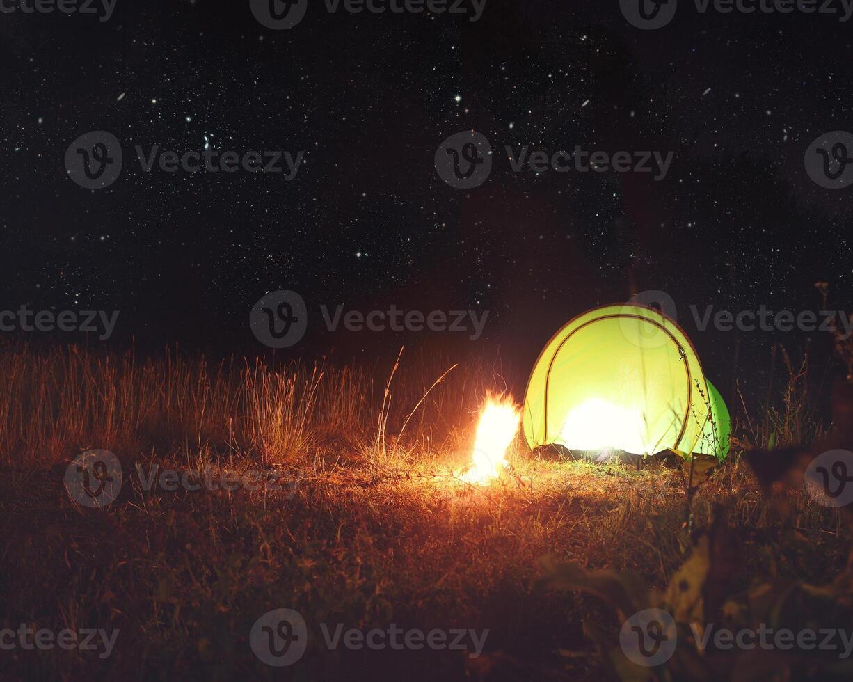 Camping tent in the forest at night under the stars photo