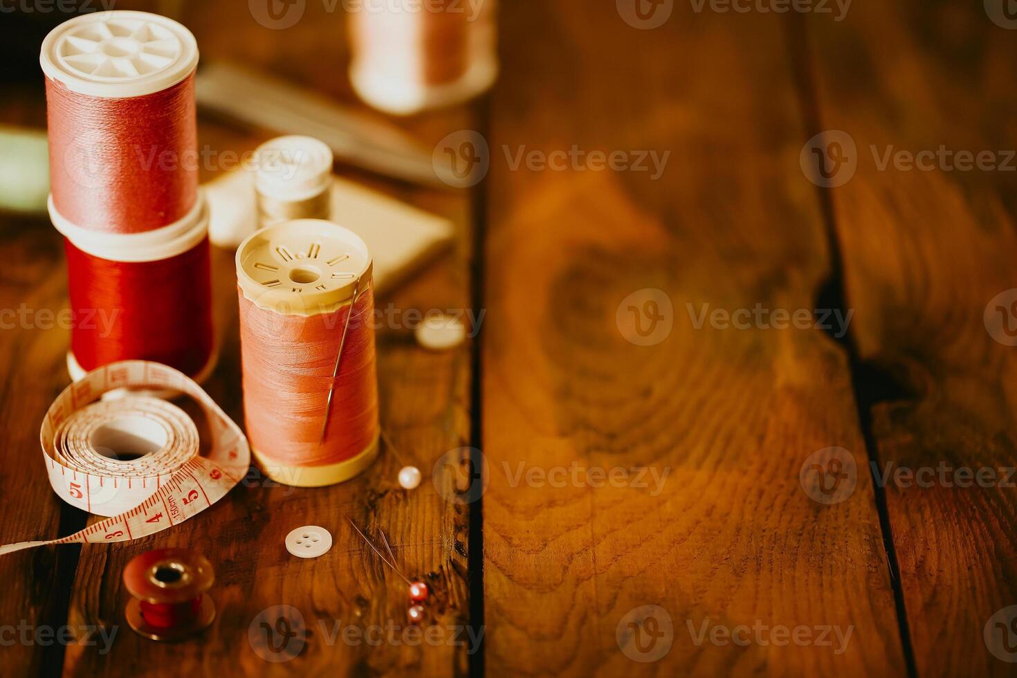 Sewing supplies on wooden table photo