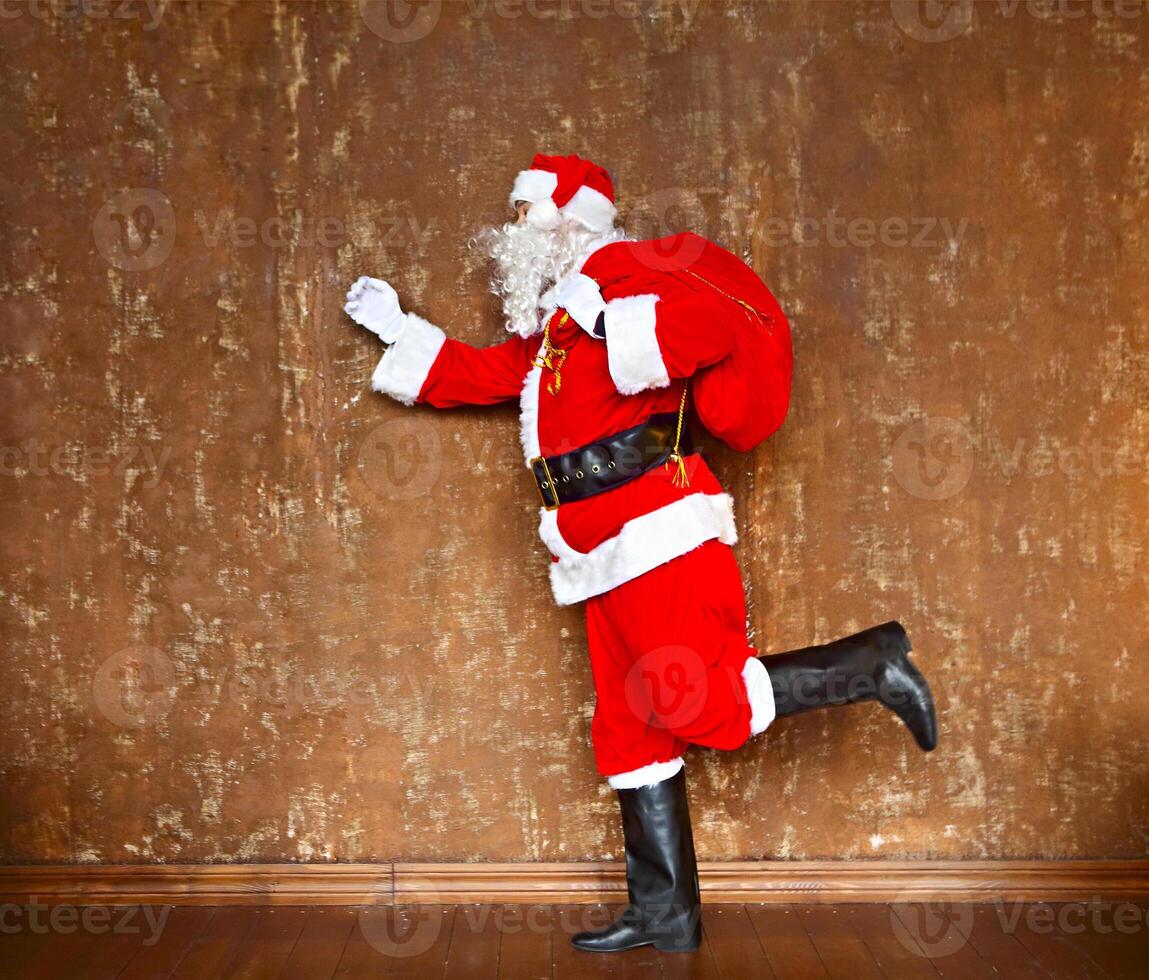 Santa Claus walking with the bag of the presents photo