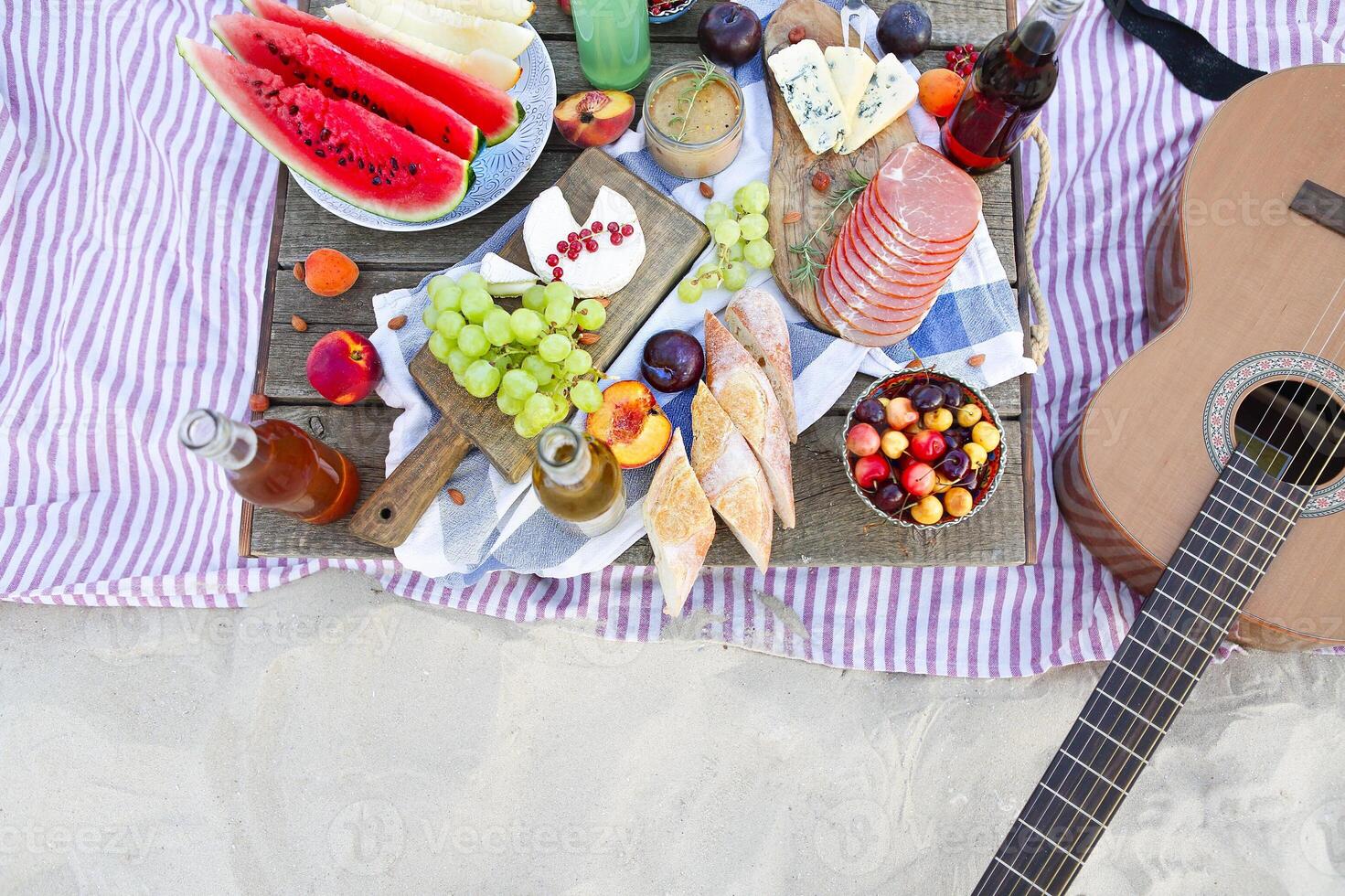 Picnic on the beach at sunset in the style of boho photo