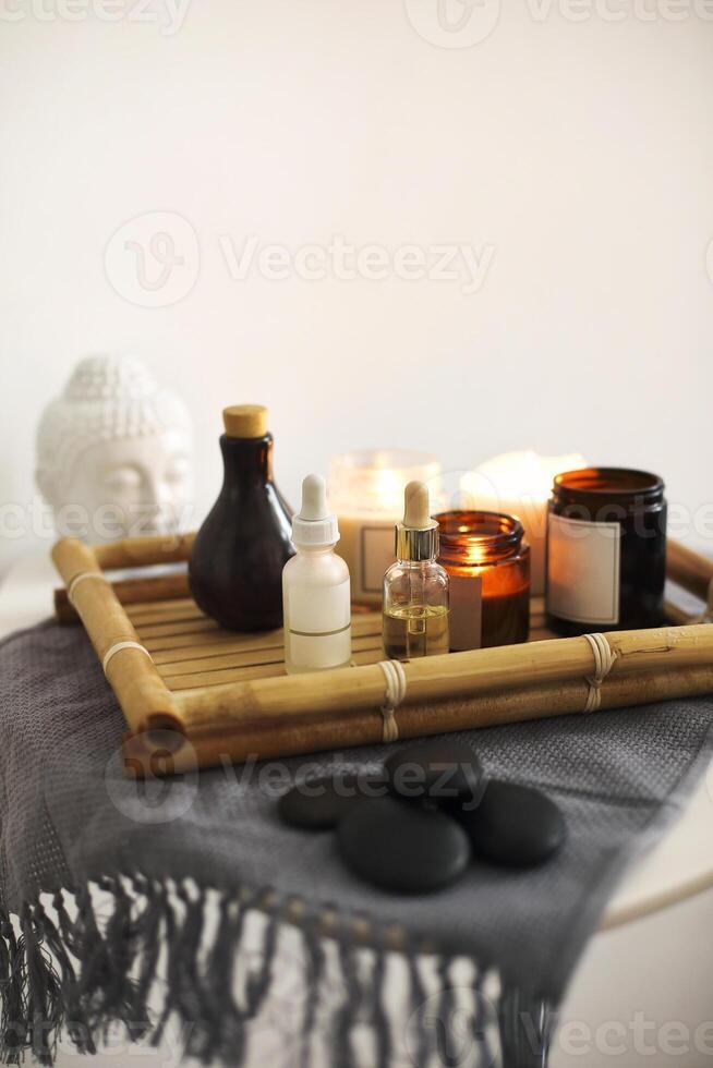 Candles and skincare products on table photo