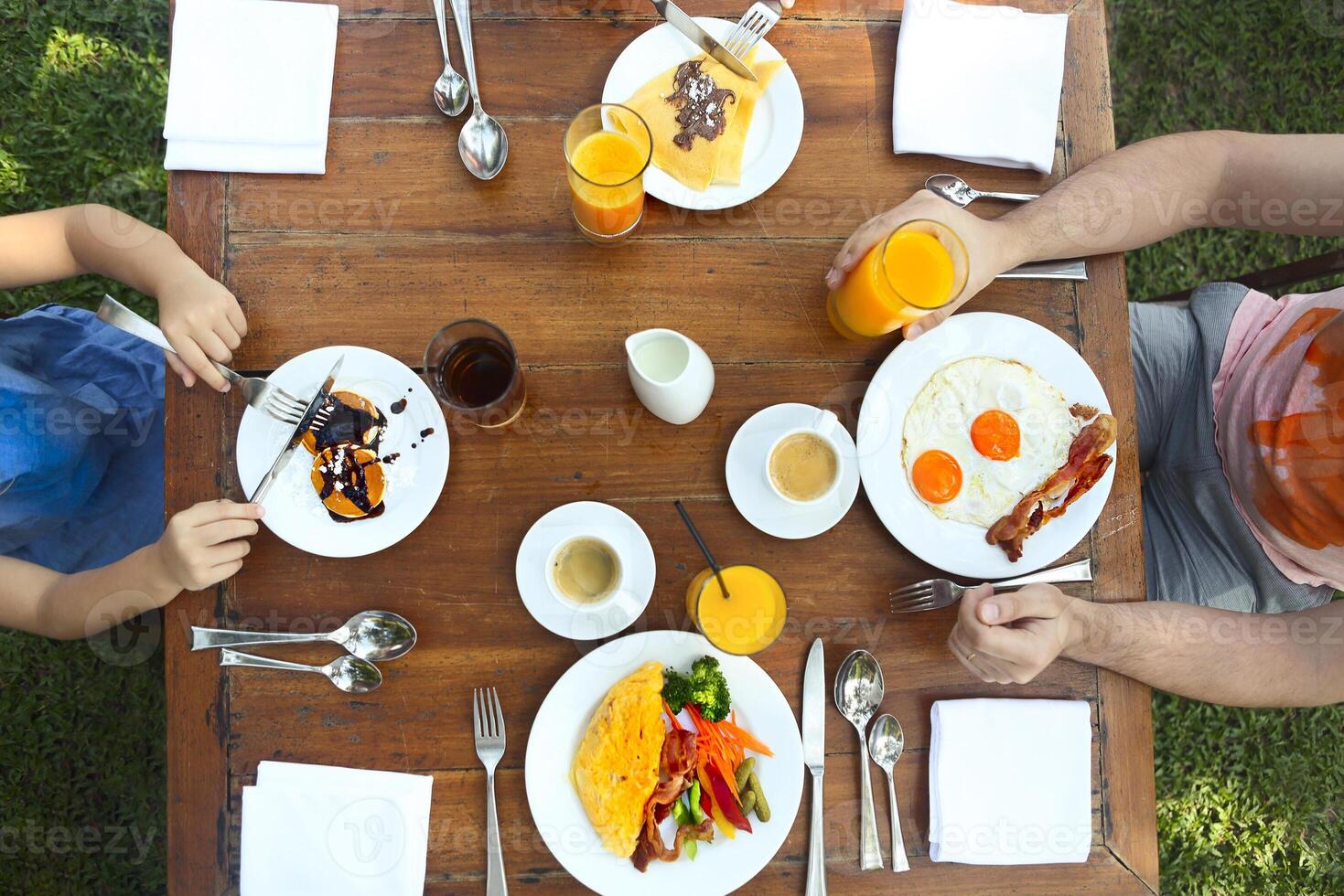 Continental breakfast with pancakes, eggs, bacon, orange jiuce and coffee. Top view photo