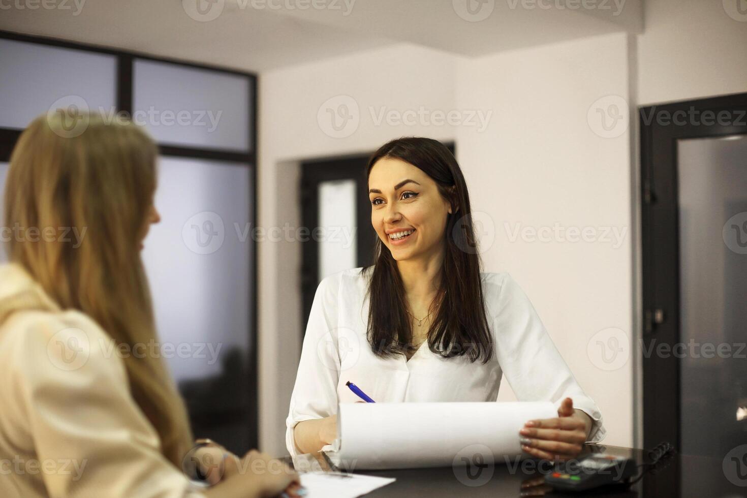 Woman writing appointment of client in salon photo