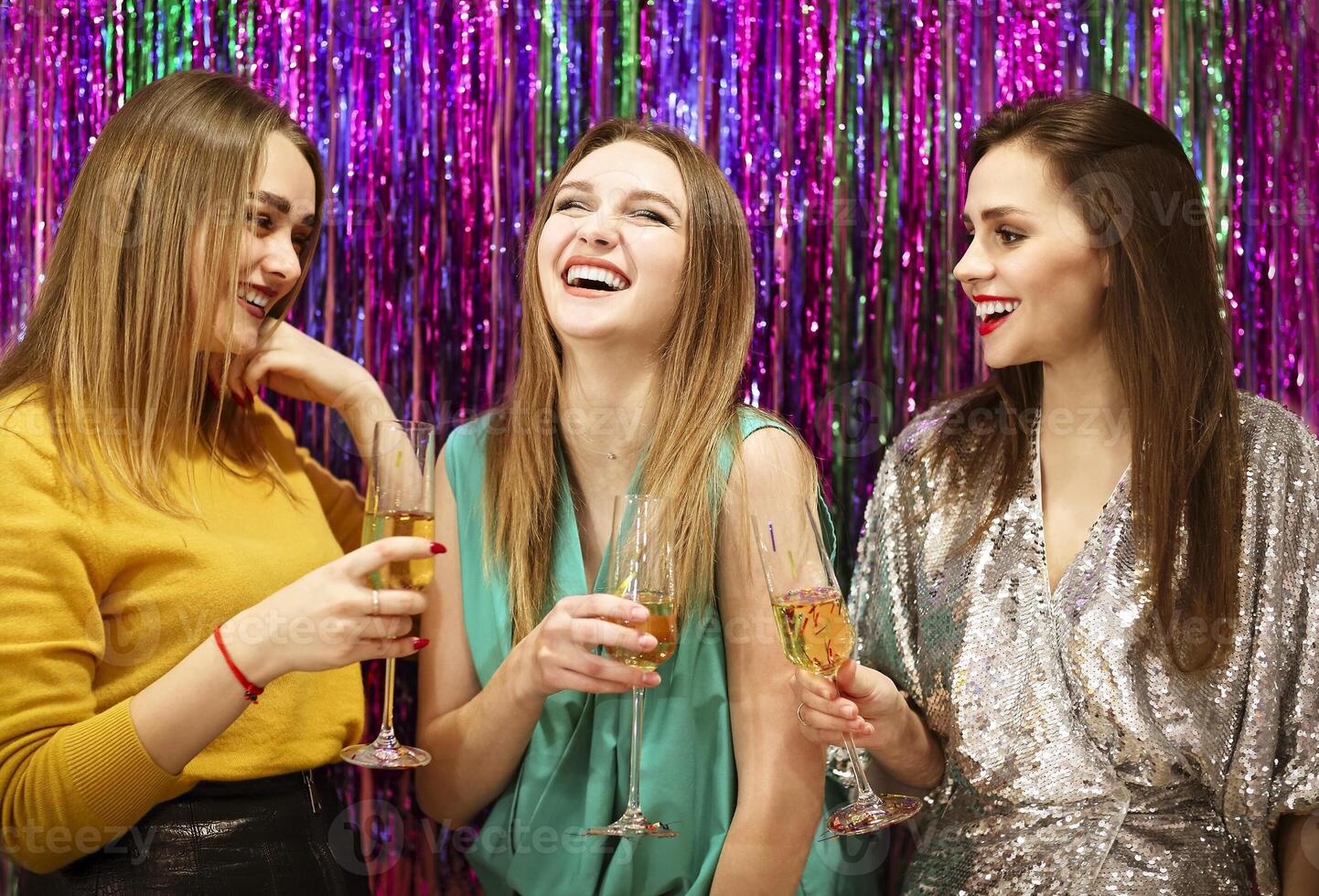 Smiling women proposing toast during party photo