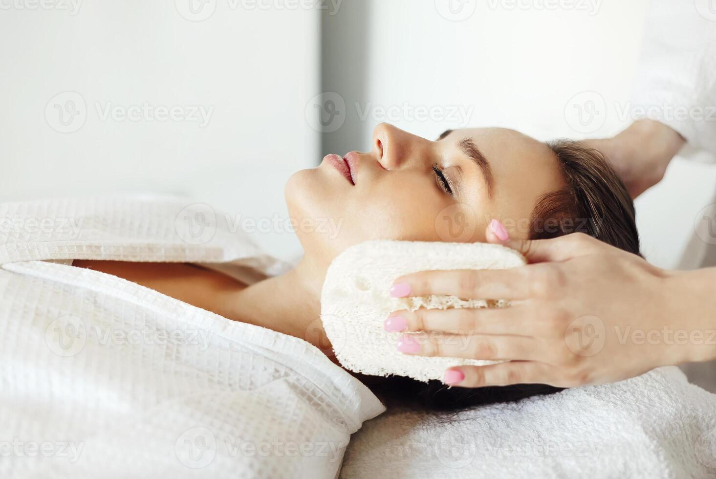 Relaxed female with a deep cleansing nourishing face mask applied photo