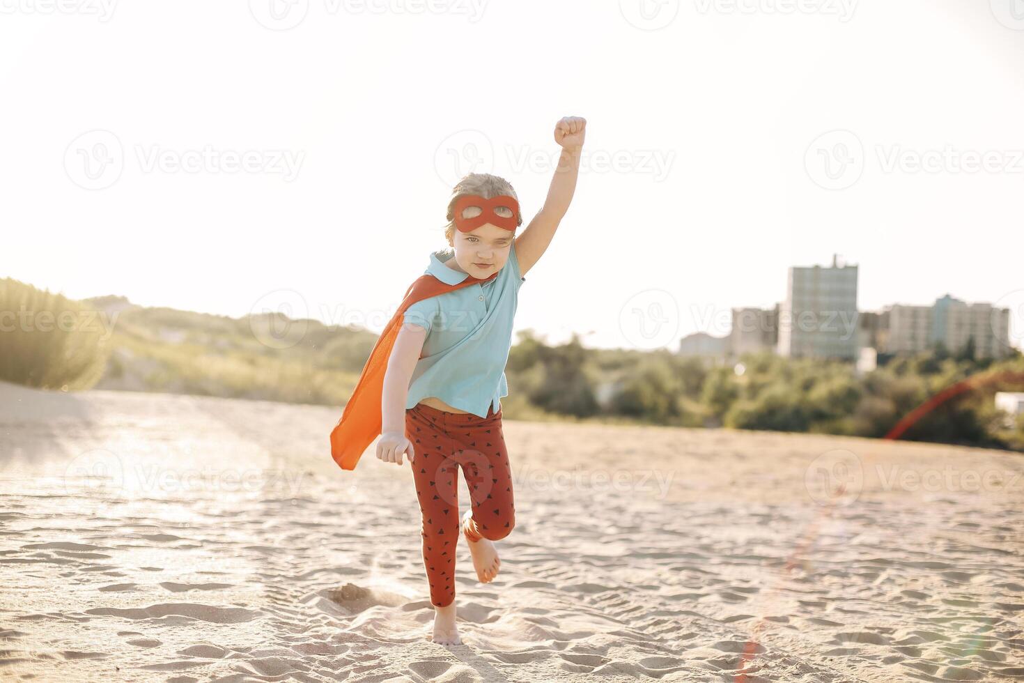 Portrait of Superhero kid against blue sky background photo