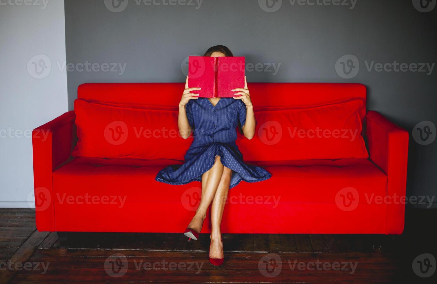 Woman reading book on couch photo
