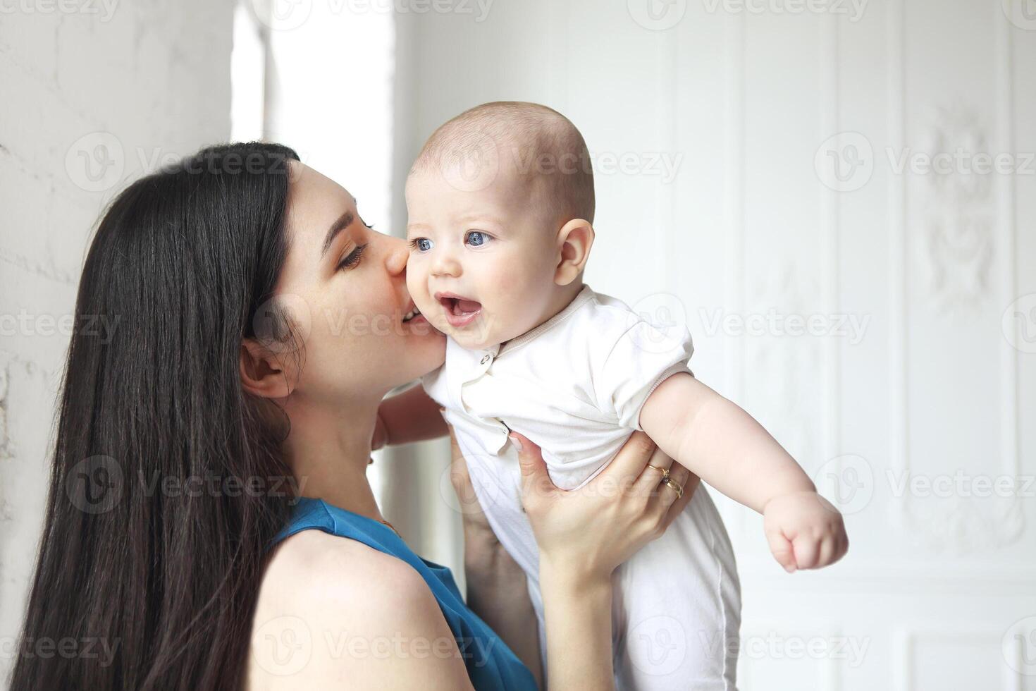 Mother holding sweet baby boy photo