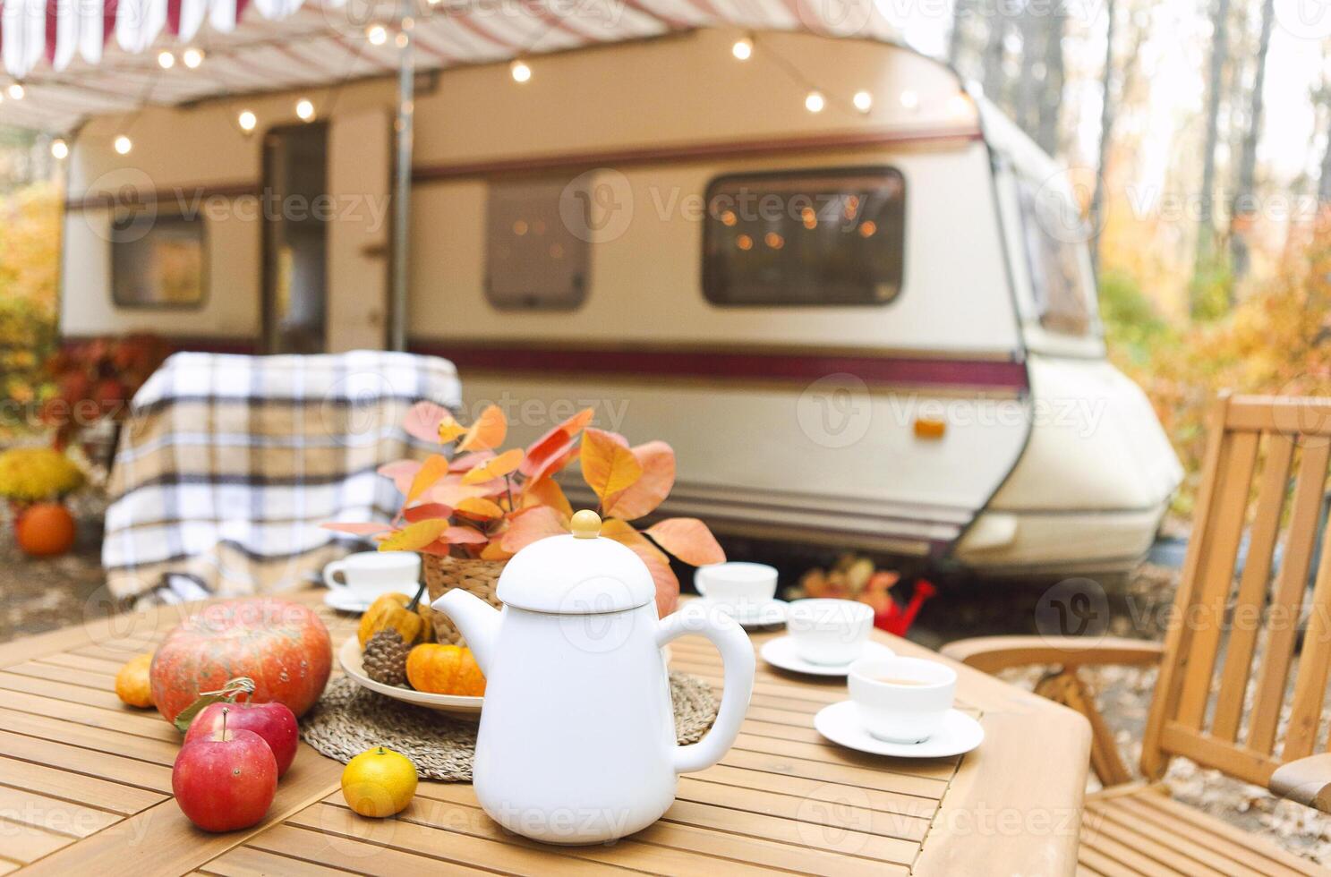 Table and chairs outside trailer in nature photo