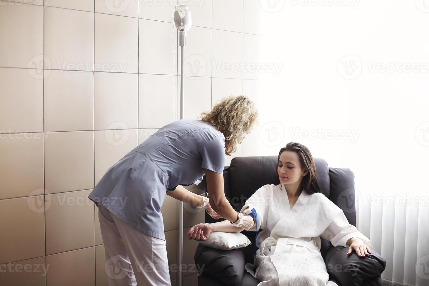 Nurse preparing patient for intravenous therapy photo