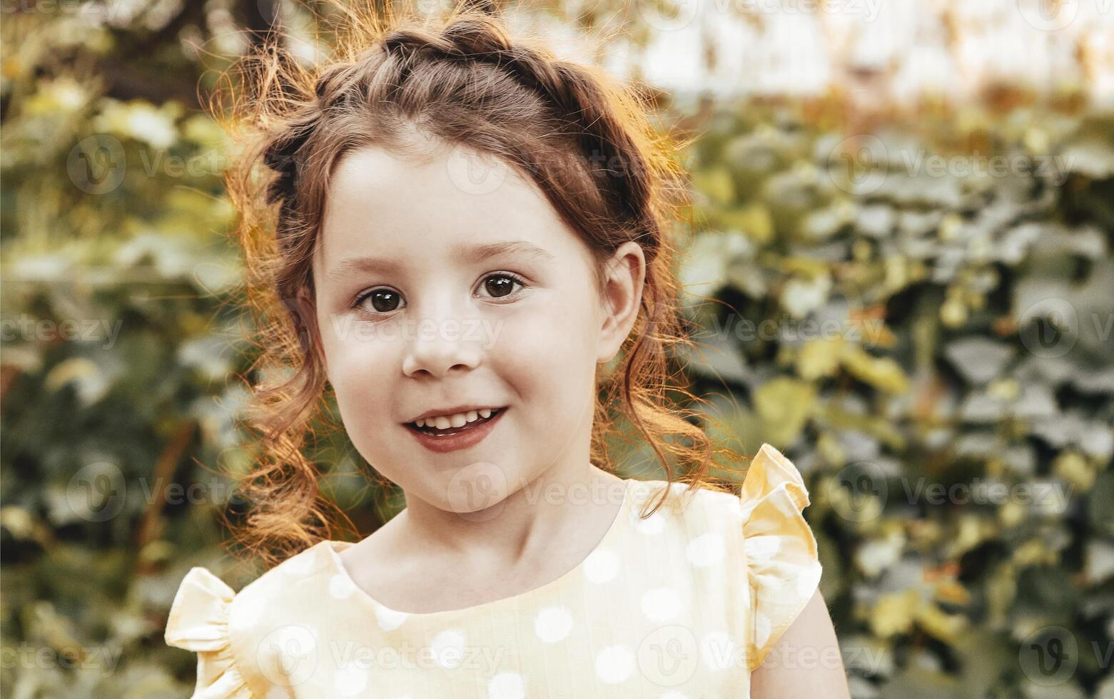 Happy little girl in garden photo