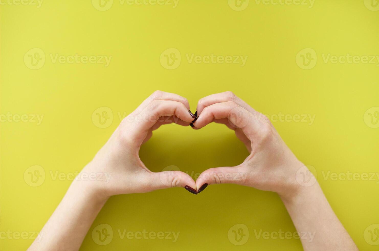 Woman making heart shape with hands photo
