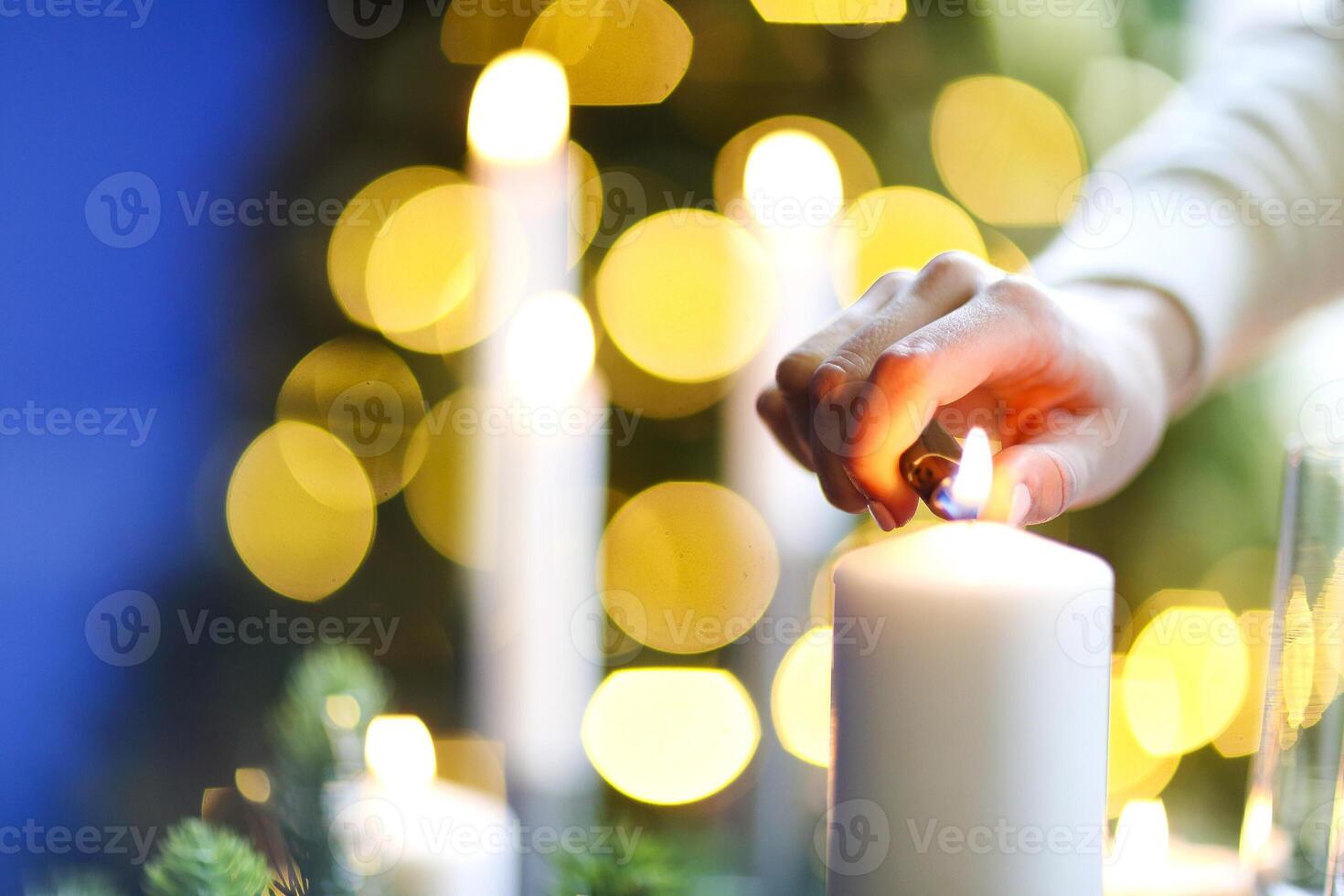 Crop woman lighting candles in evening photo