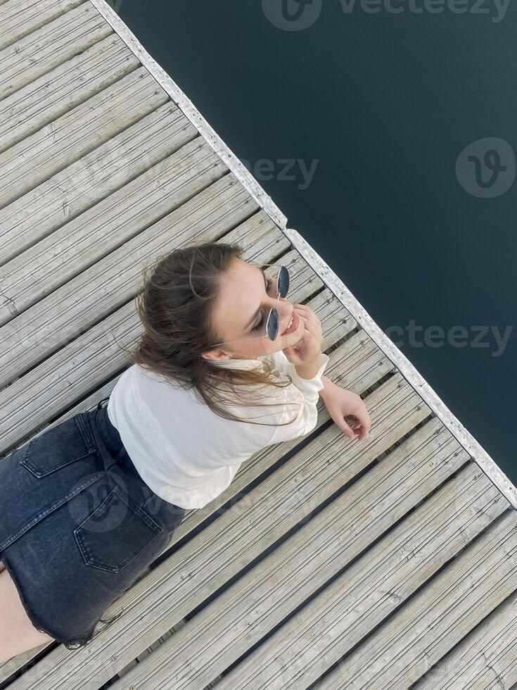 Anonymous woman playing with water on pier photo