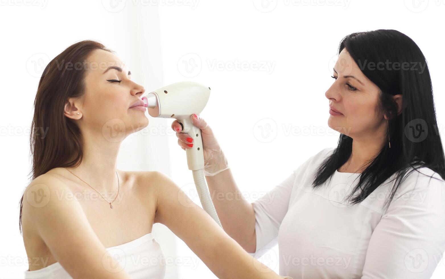 Woman on procedure of laser epilation photo