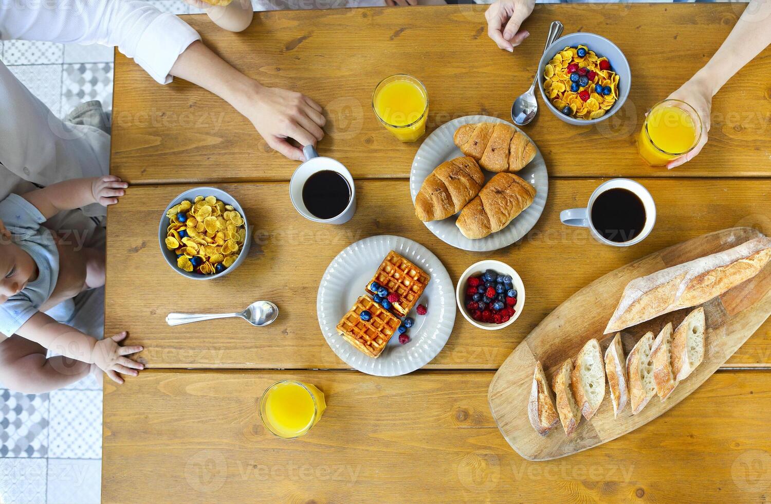 Family of four having breakfast In the kitchen photo