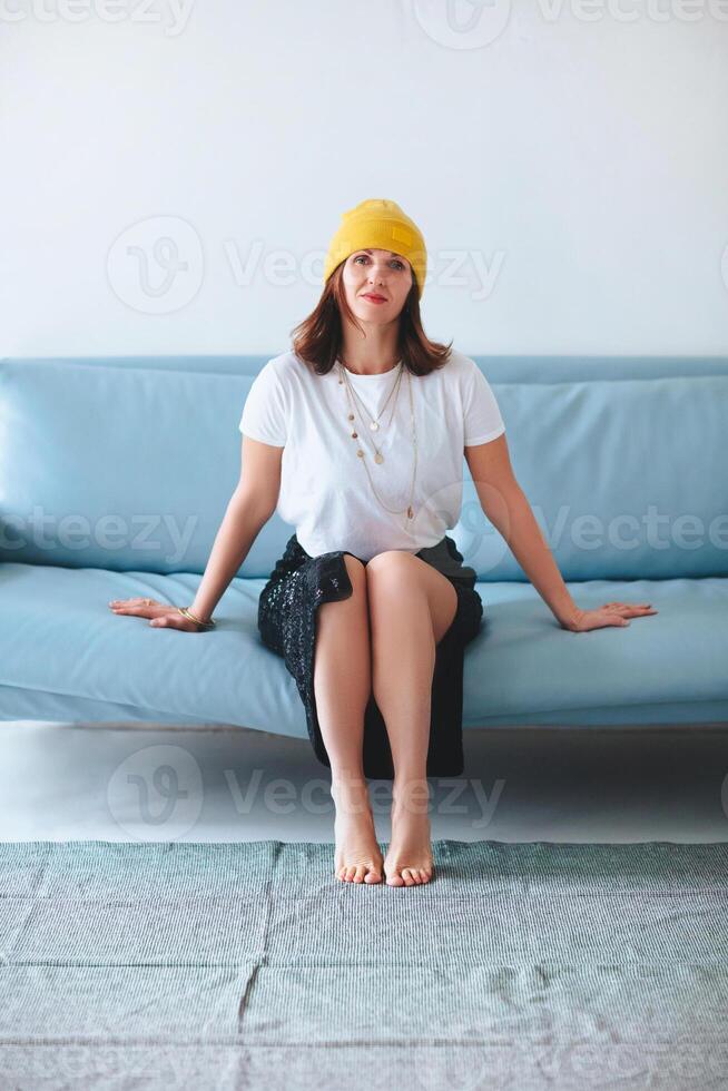 Stylish woman sitting on sofa photo