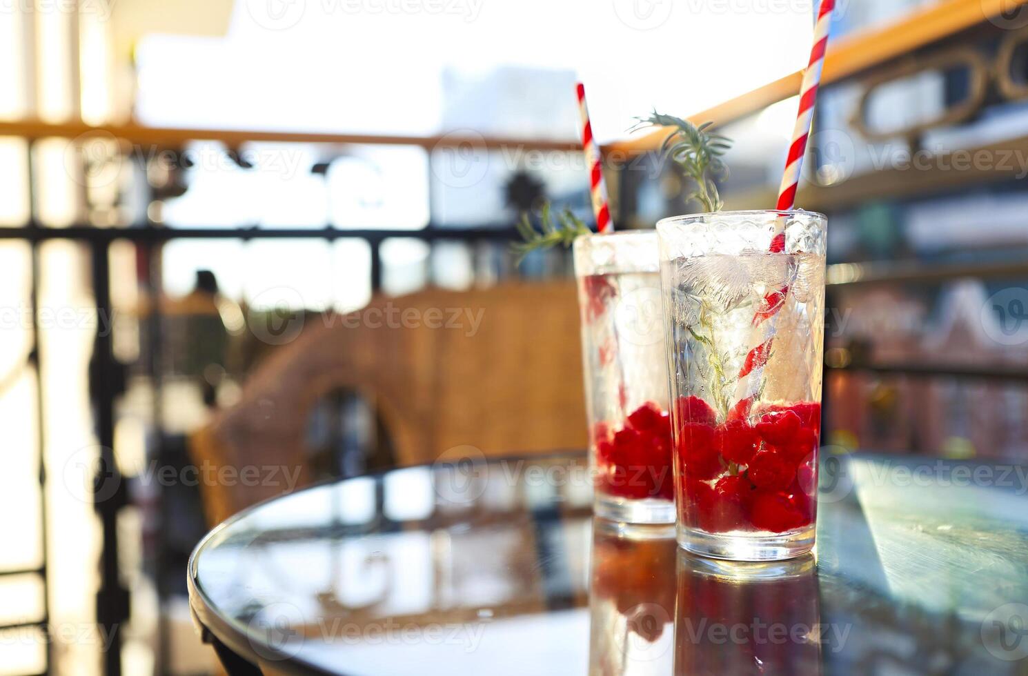 Summer refreshing lemonade with rasberry on a balcony of terrace photo