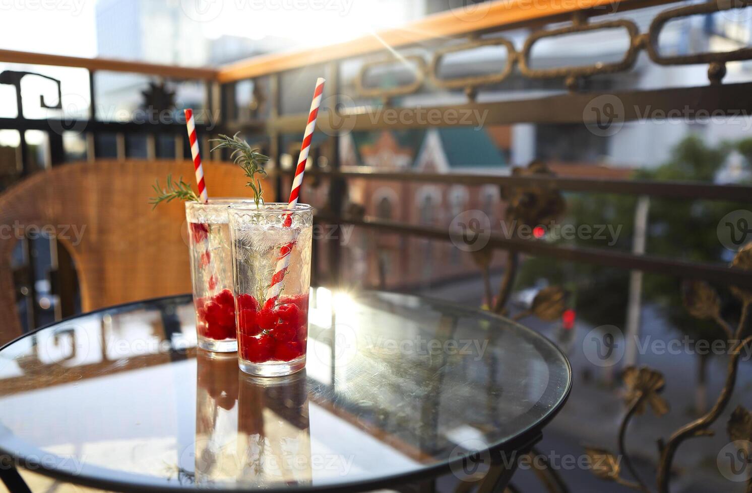 Summer refreshing lemonade with rasberry on a balcony of terrace photo