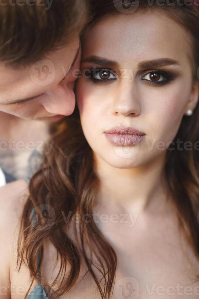 Tattoed stylish guy hugging his beautiful girlfriend photo