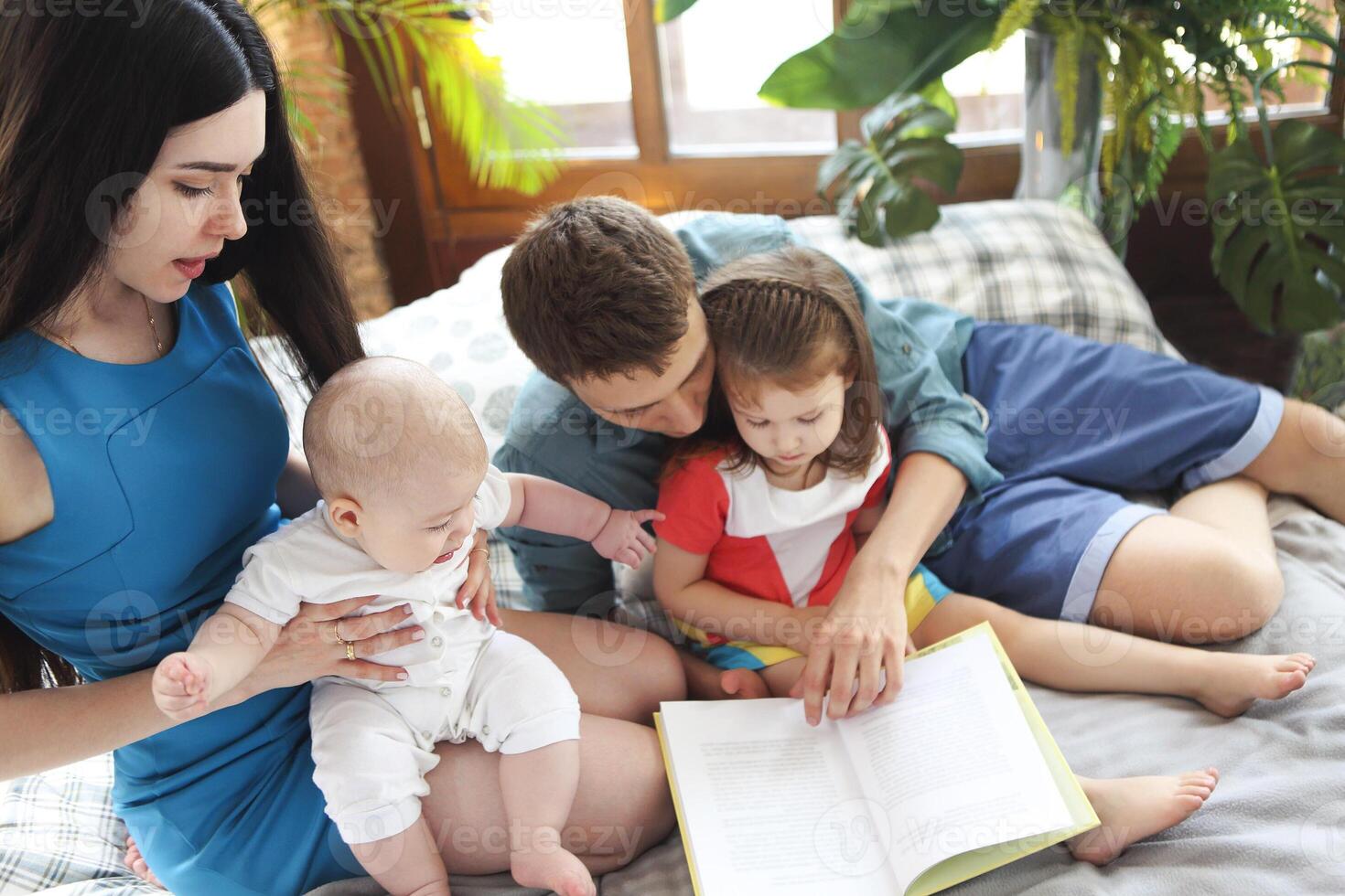 Parents reading the book to their children photo