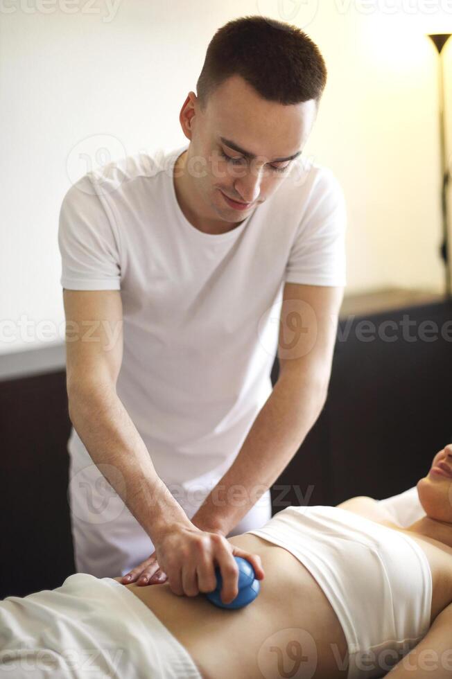 Master doing vacuum massage for client photo