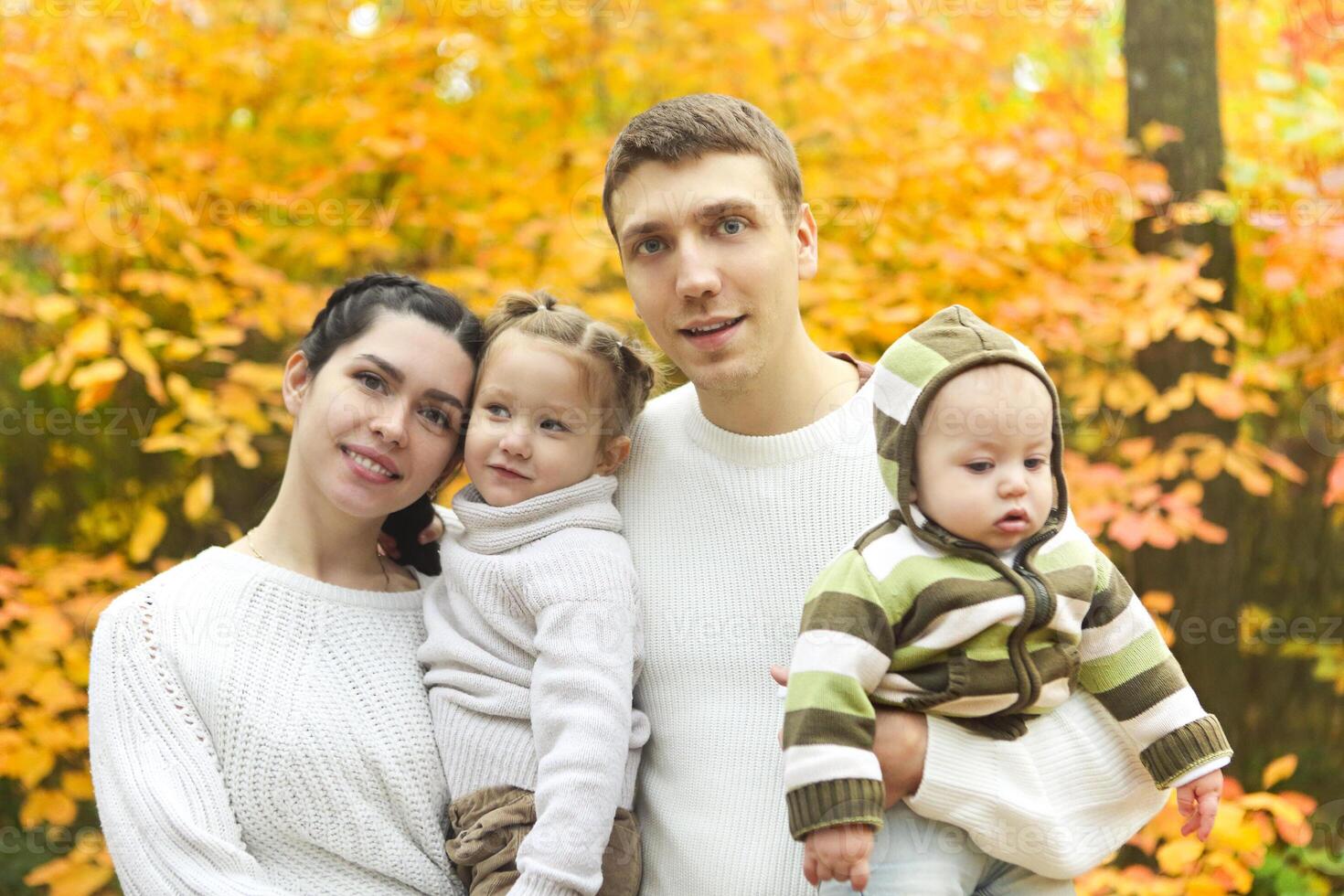 Smiling family with two children outdoors photo