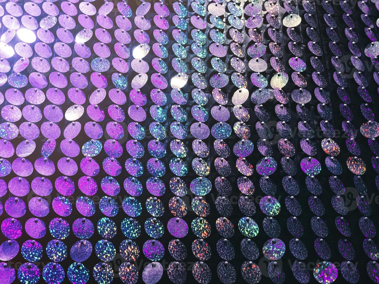 Colorful background of glowing sequins photo