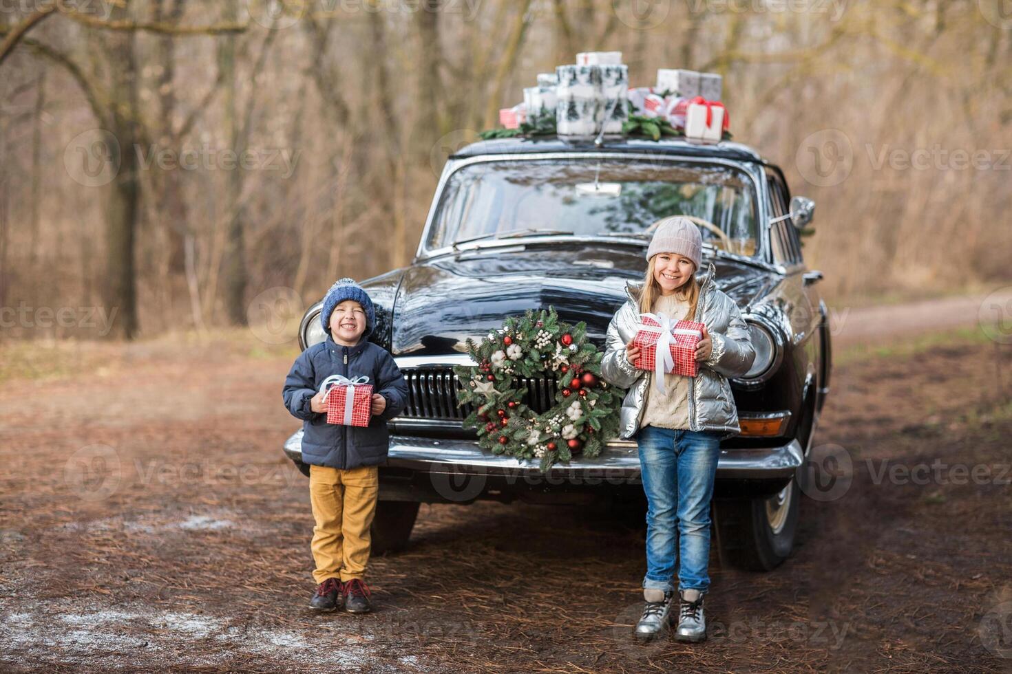 Siblings with gifts at vintage car in park photo