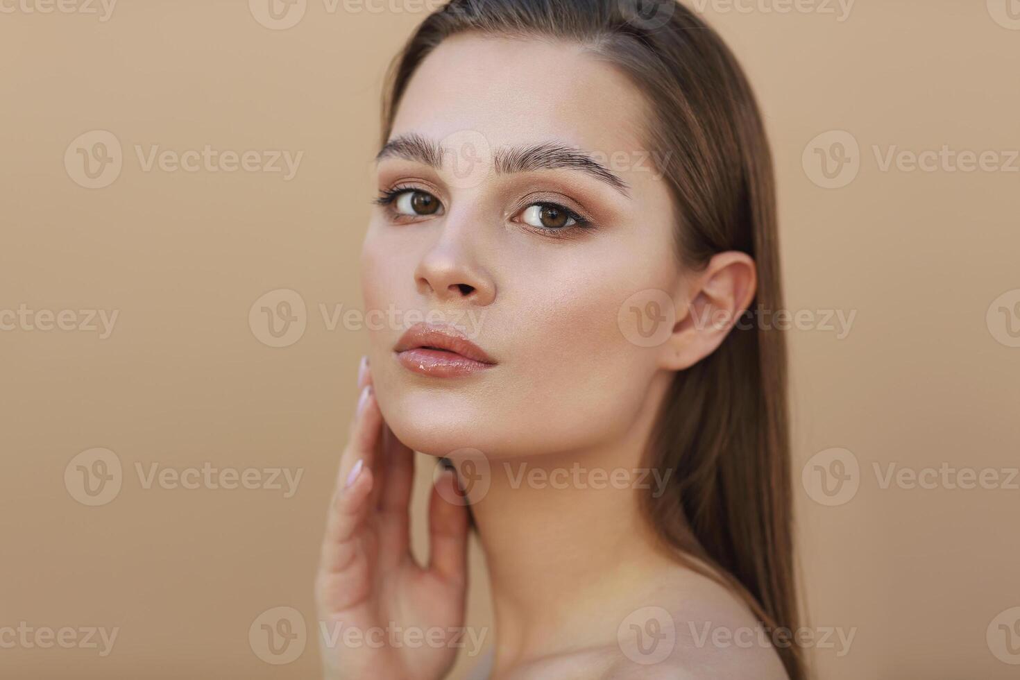 Beautiful Young Woman with Clean Fresh Skin touching own face. Facial treatment photo